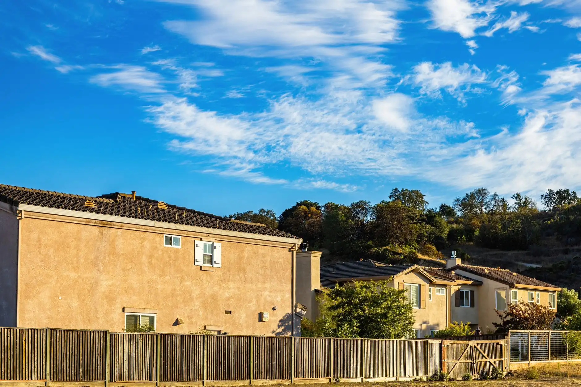 Wood perimeter fence along a row of suburban homes